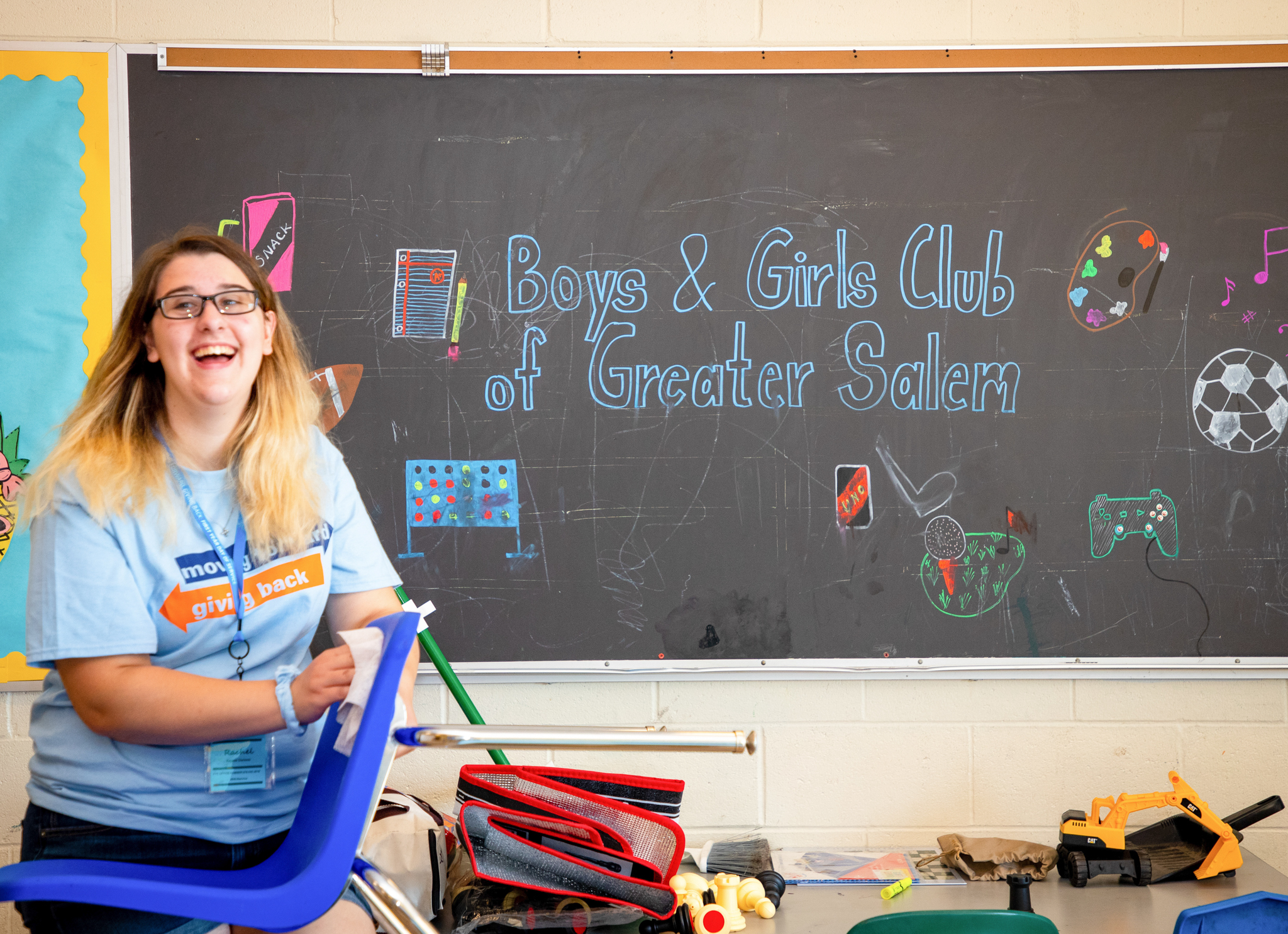 At the 2019 First Year Day of Service, a Salem State student helps clean at the Boys and Girls Club in Salem.