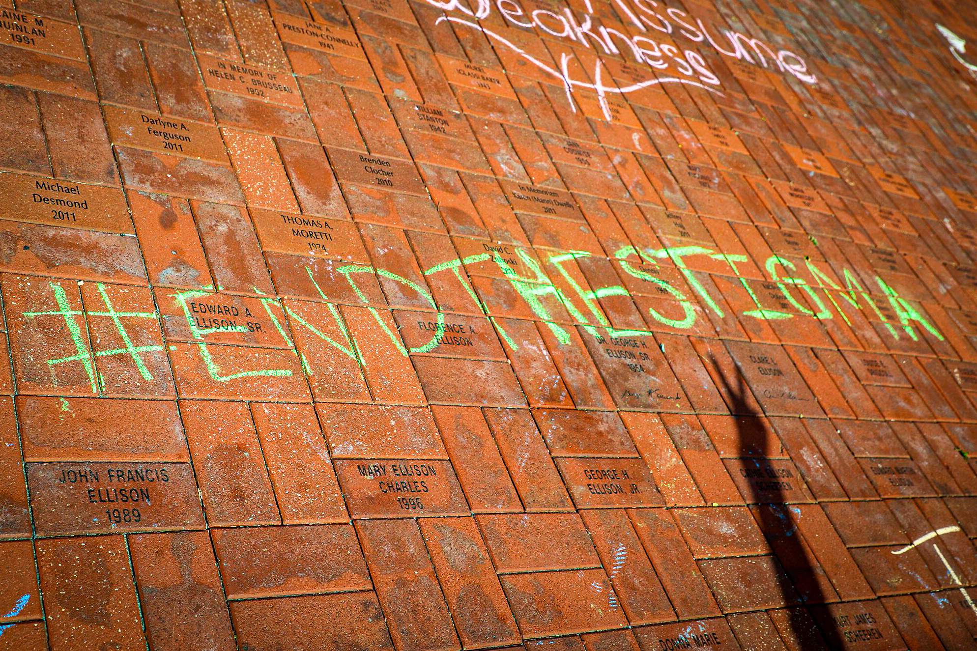 "#End the Stigma" is written in chalk on Alumni Plaza as part of a mental health wellness campaign at Salem State.