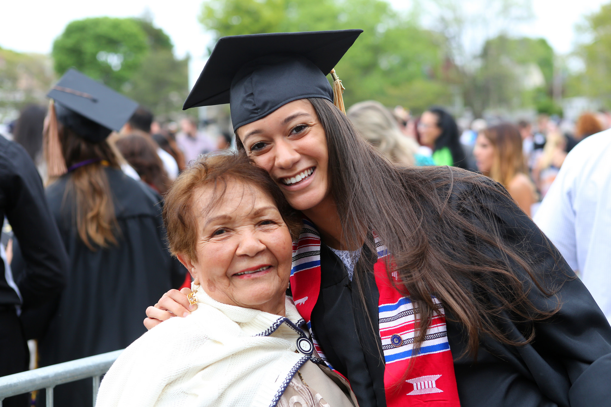 A Salem State graduate poses with a family member