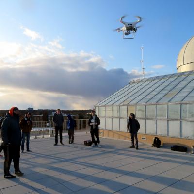 Students working with drones on the roof of Meier Hall