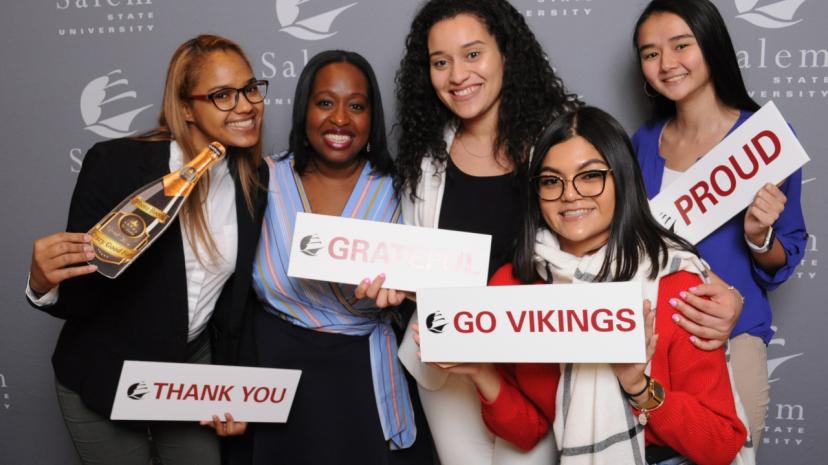 scholarship recipients celebrate with signs of Gratitude Thank You, Go Vikings, Proud