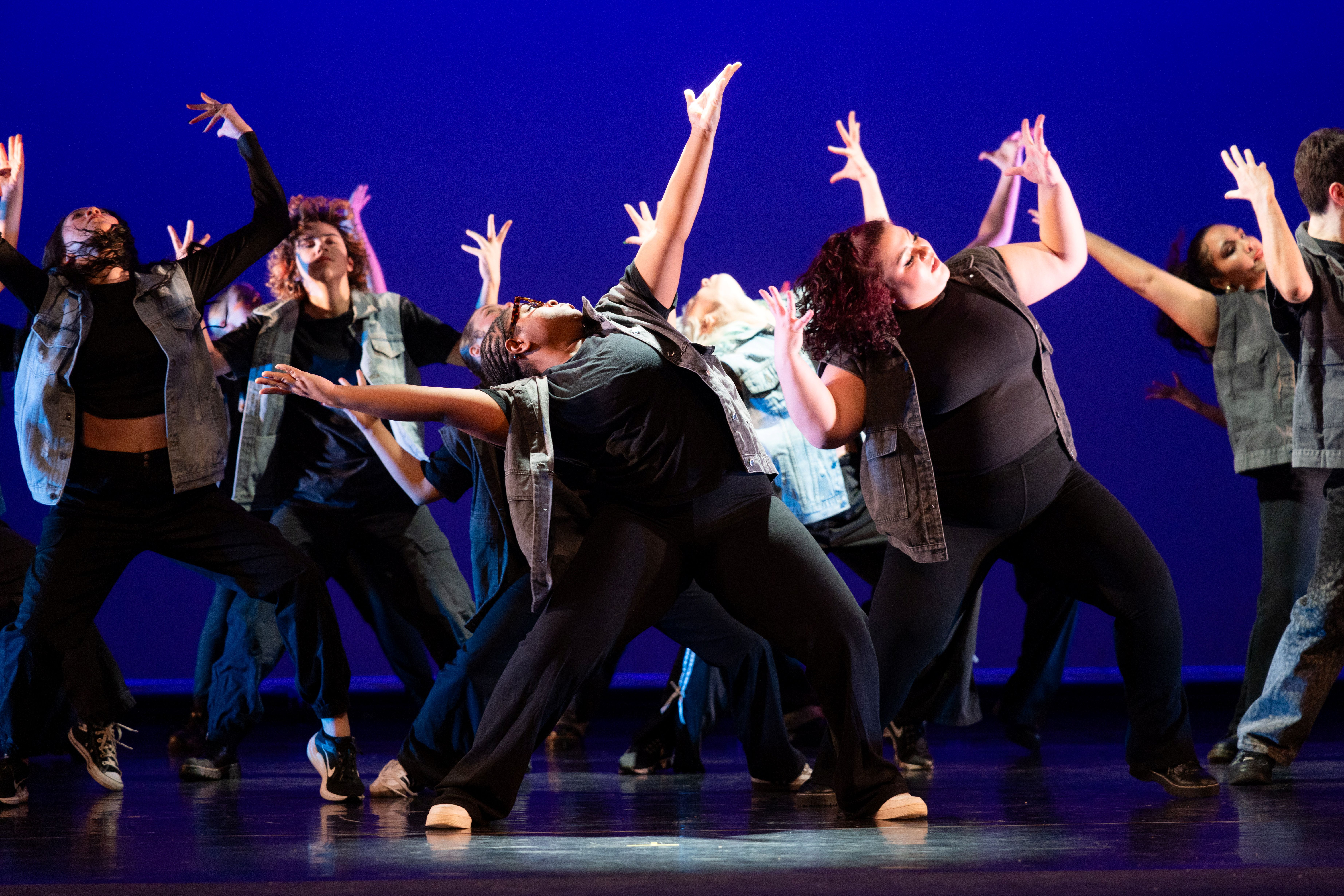 Group of dancers with their arms in the air