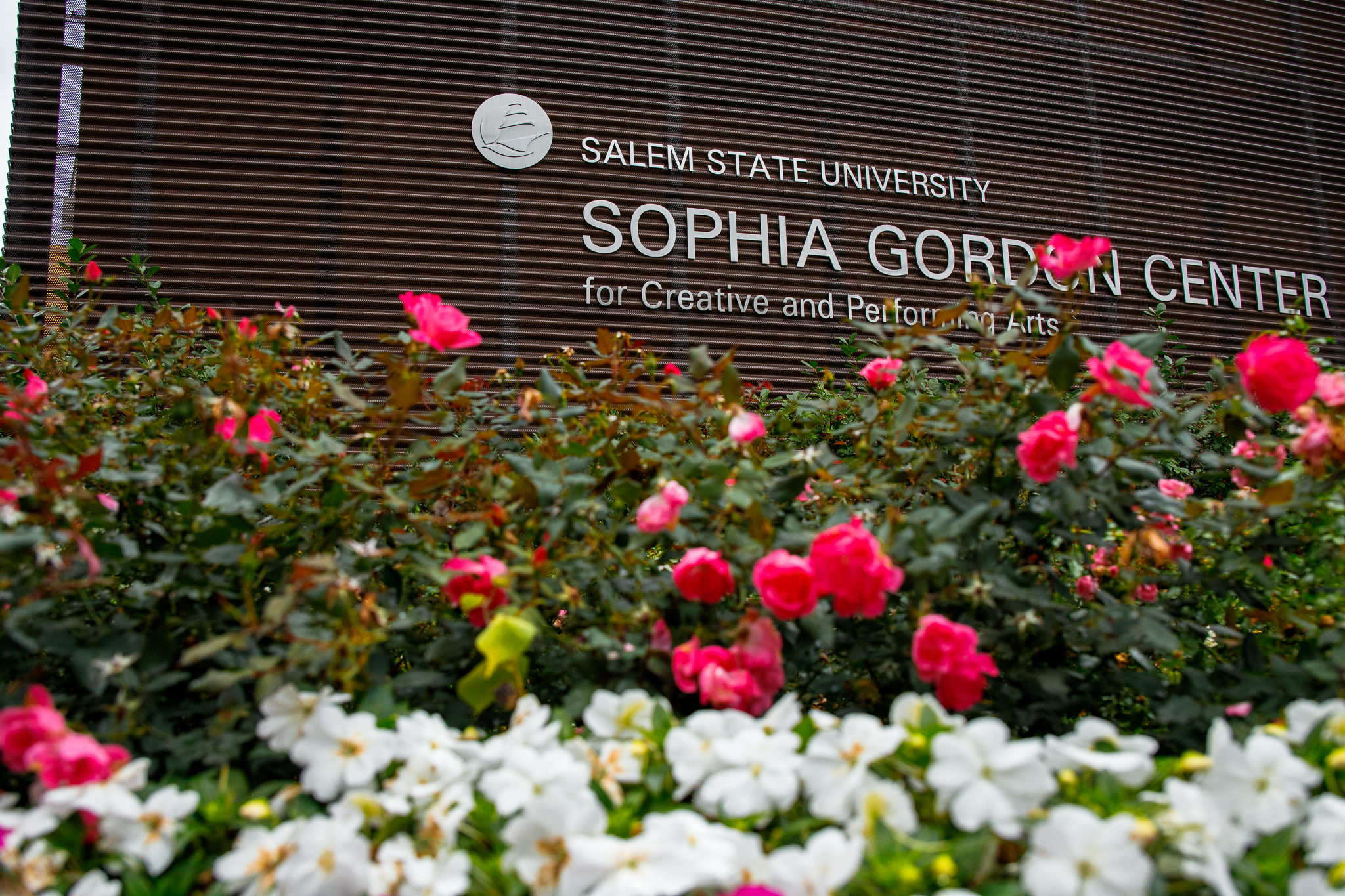 Sophia Gordon Center with flowers framing the building sign.