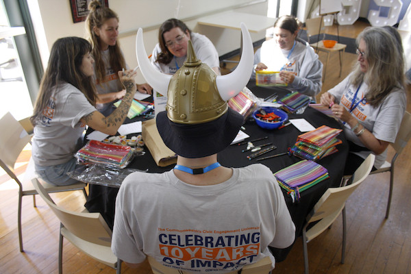 First Year Day of Service seated around a table working on a project