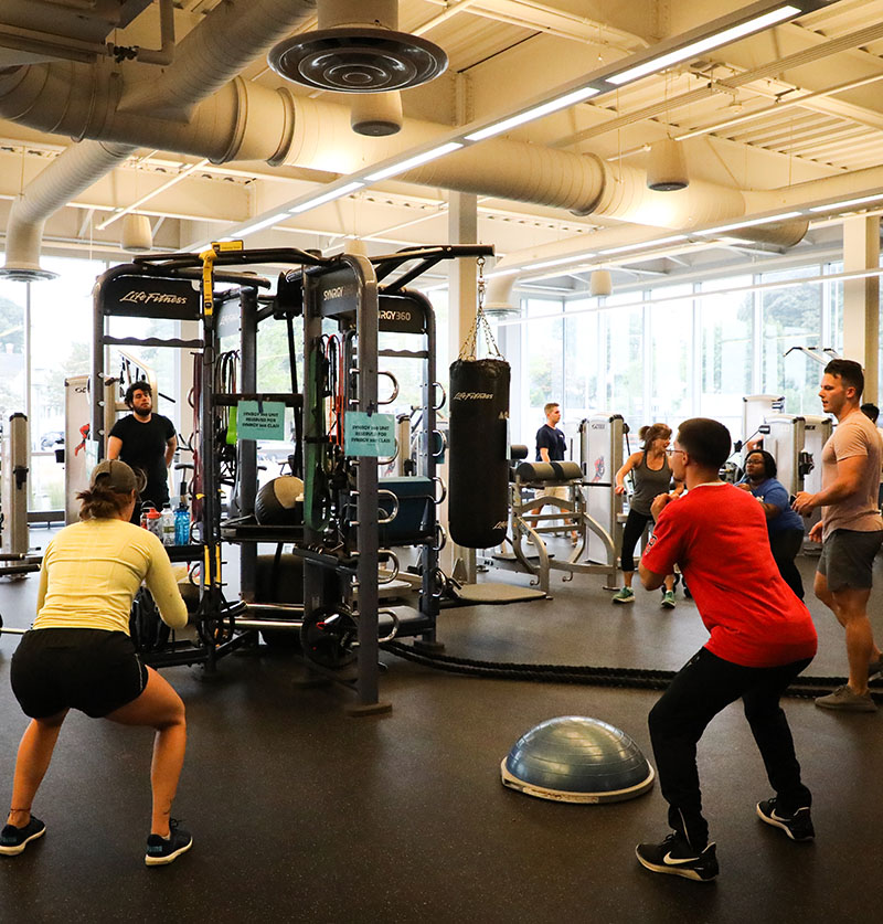 Students in a group workout on the fitness center floor