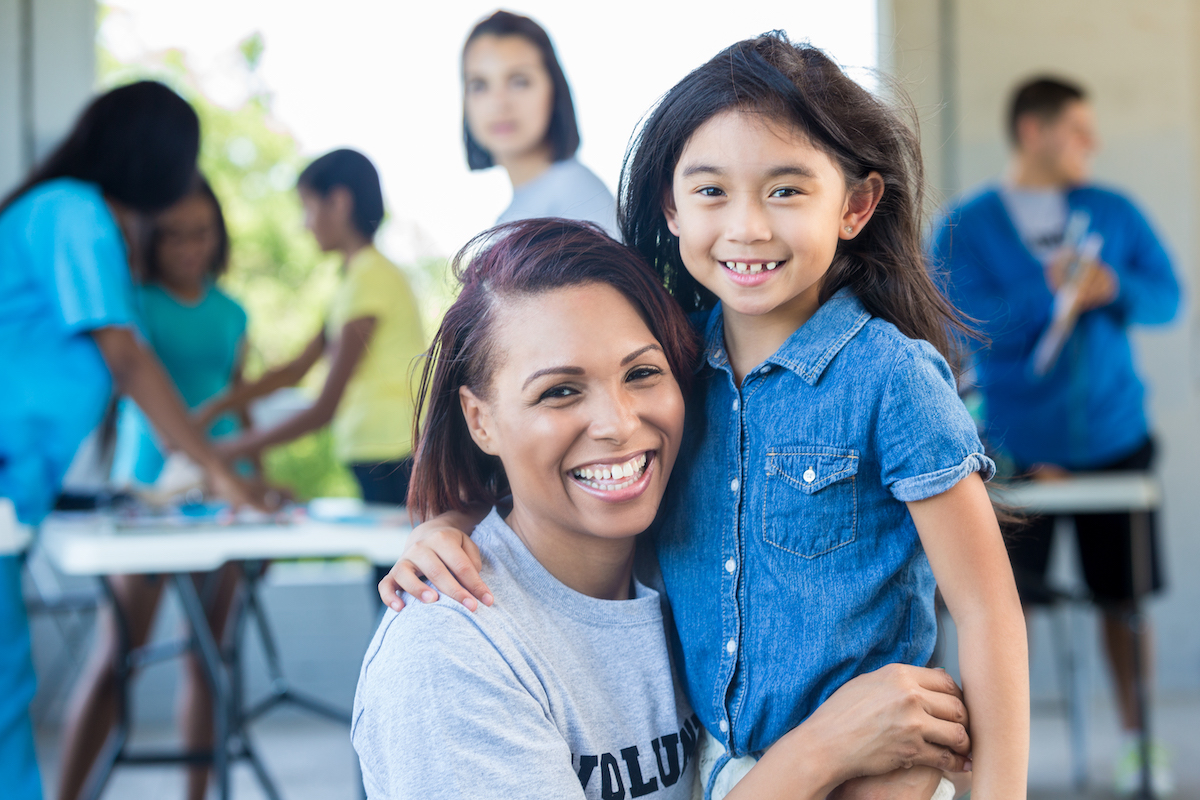 A social worker and child smiling