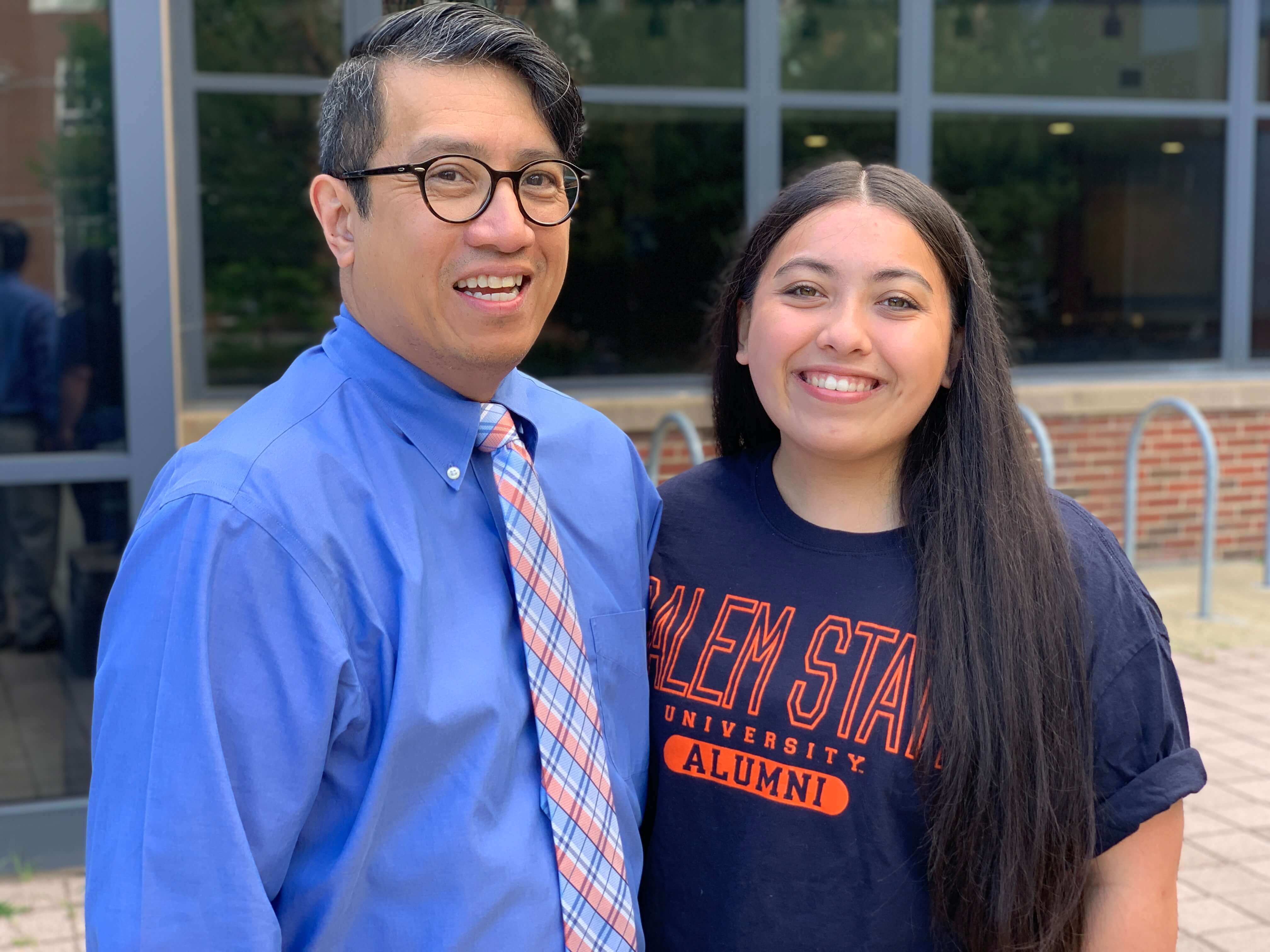 A parent and their student pose together to celebrate graduation