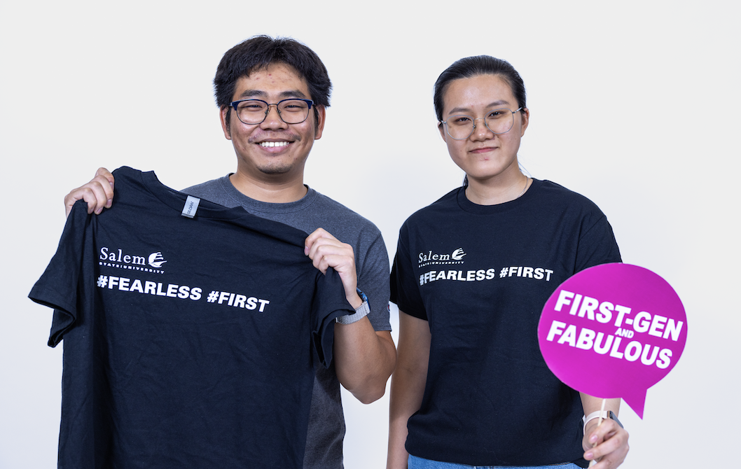 Salem State first-gen students hold up a shirt that says "#fearless #first" and a sign that says "First-gen and fabulous"