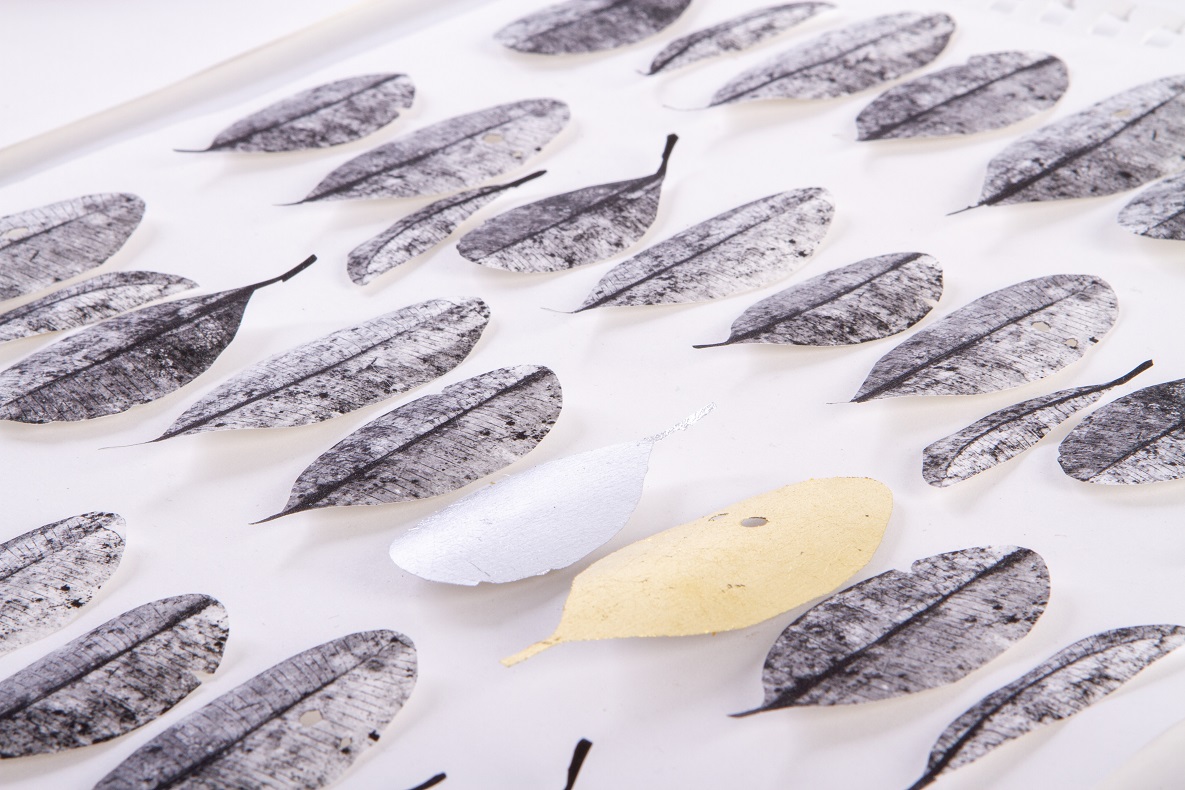 Image of silver leaves with one gold leaf