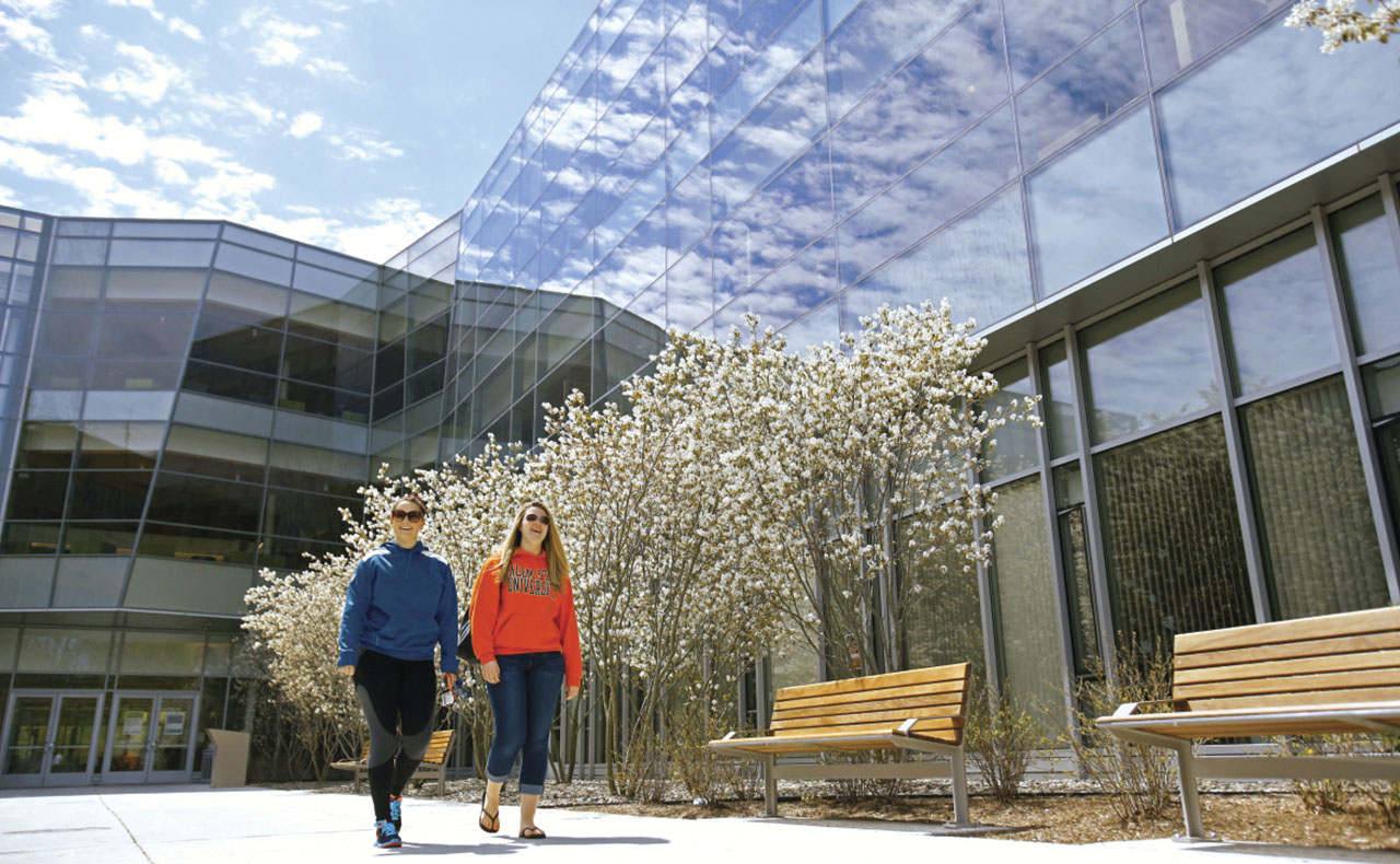 Students walking in front of the library.