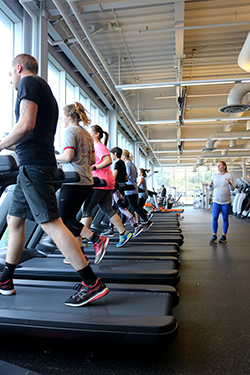 Students on a treadmill with an instructor behind them