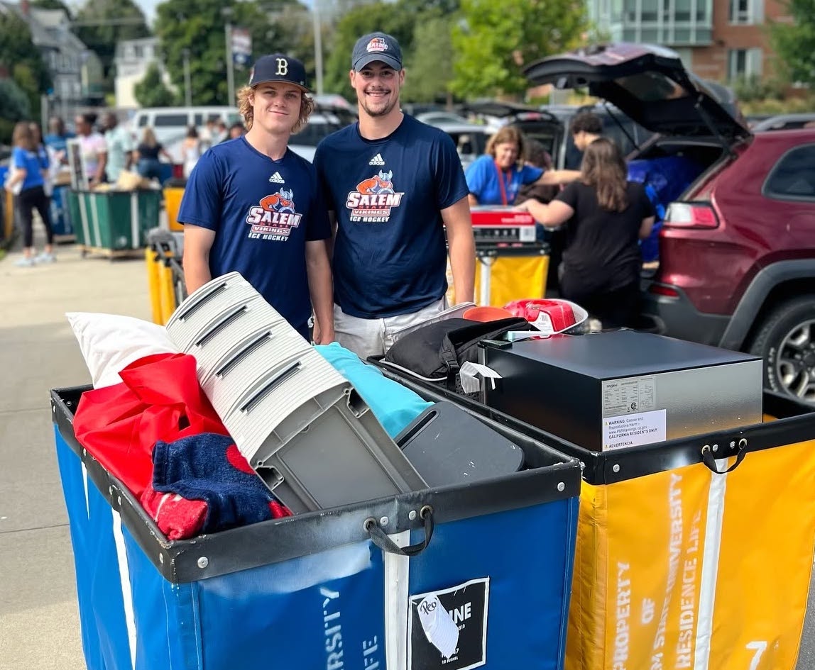 Two students in Vikings gear with full move-in carts