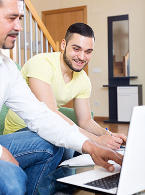 A father helps his teenage son with homework