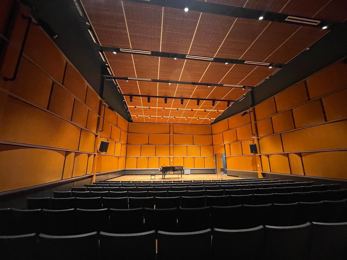 Photo of chairs and a stage with a piano