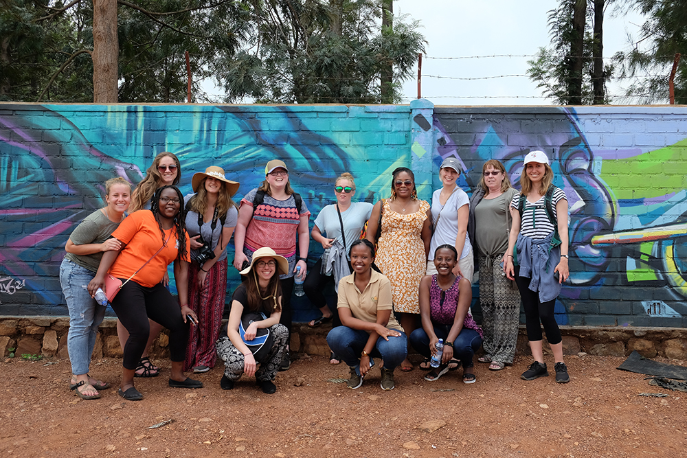 A group of students in front of a van in Rwanda