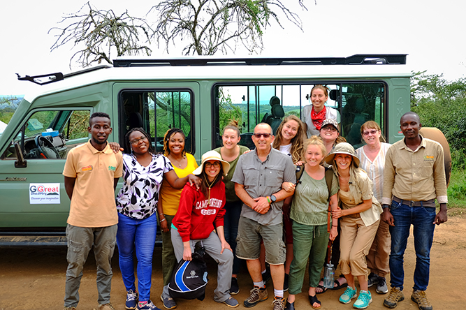 A group of students in front of a van in Rwanda