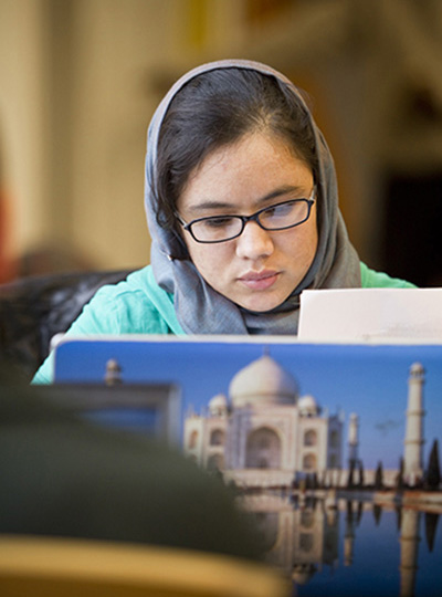 Salem State student works on a class project using a laptop