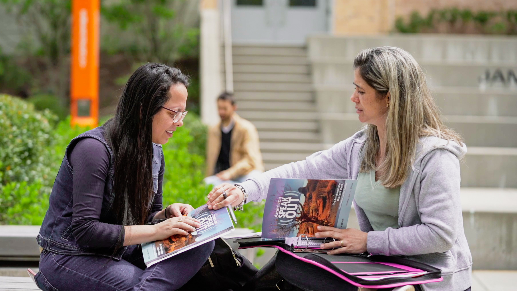 Two students talk outside at Salem State