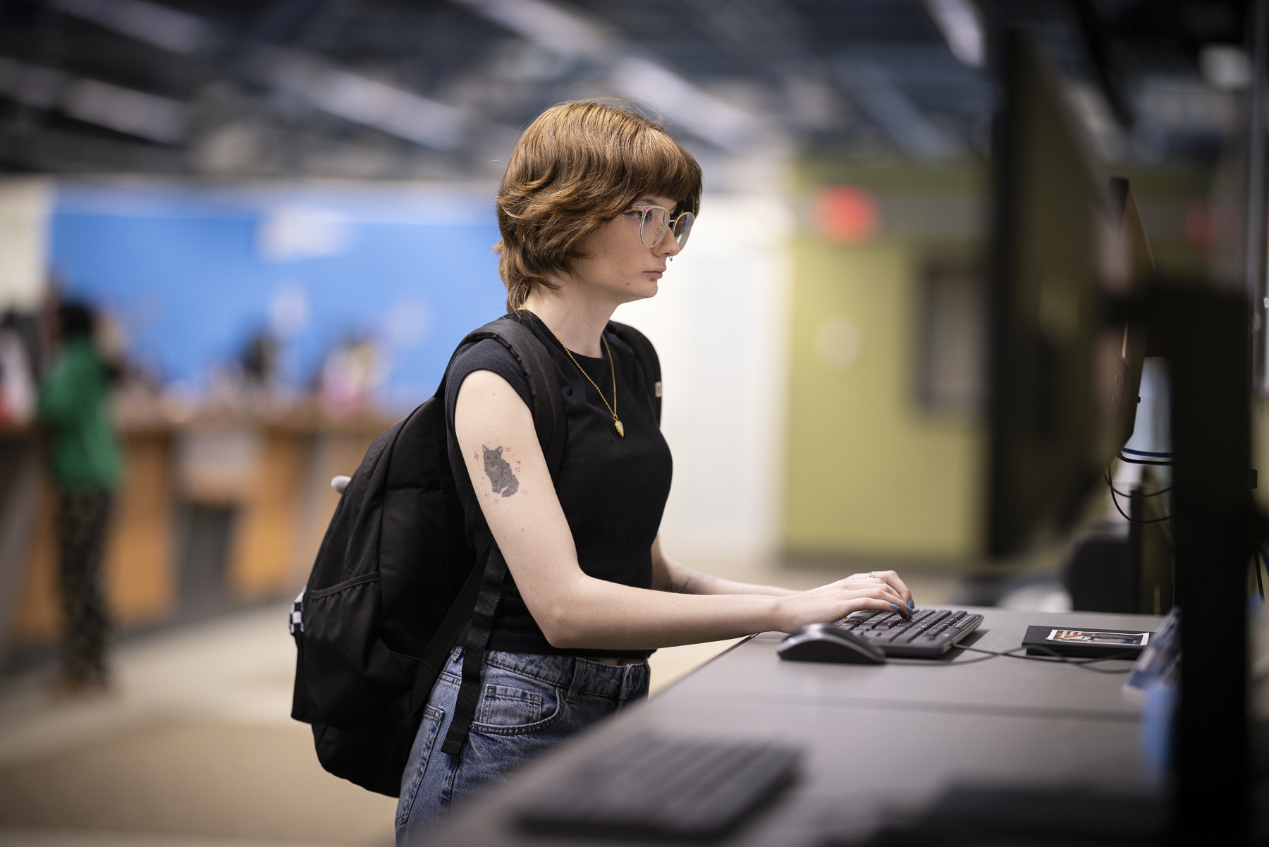 A student using a computer workstation at the Student Navigation Center at Salem State.