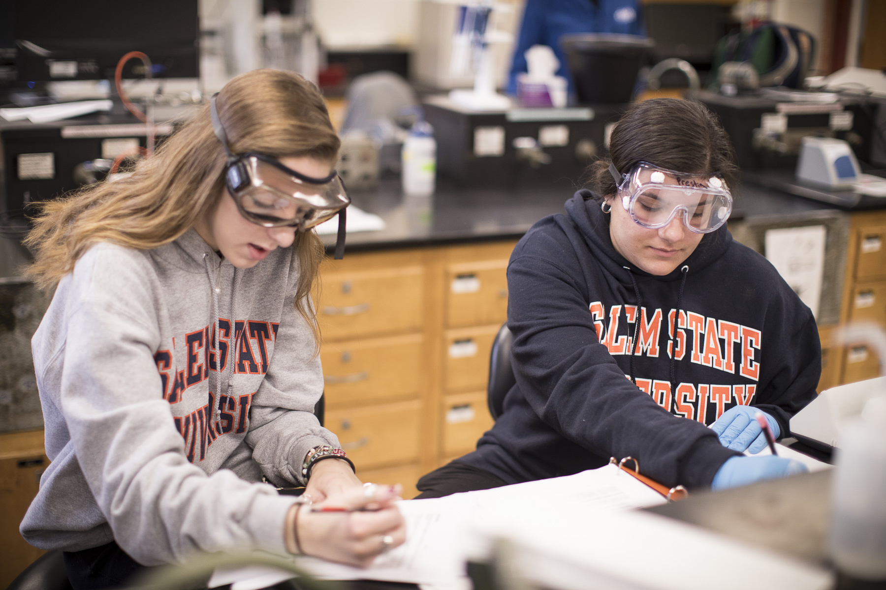 Chem and physics students in goggles 