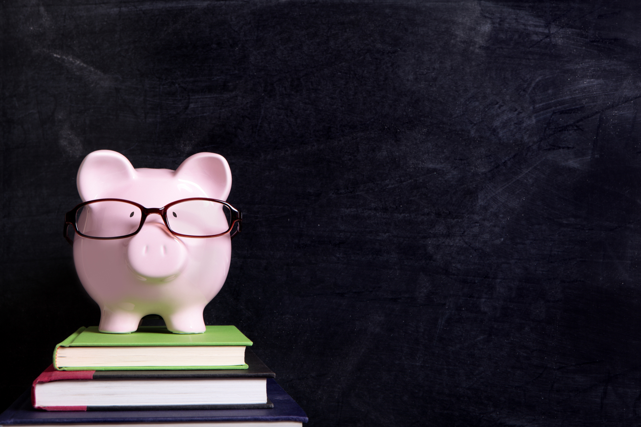 Piggy bank on textbooks