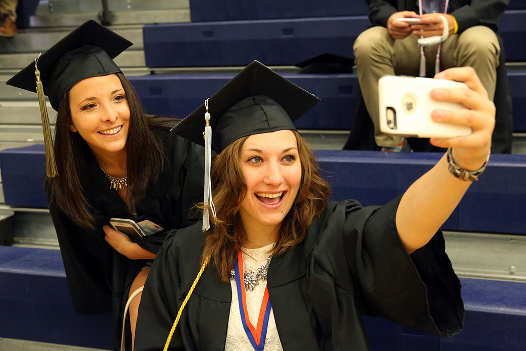 Salem State graduates take a selfie before the ceremony