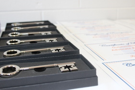 Photo of silver keys in boxes (award that recipients receive) with the corner o…