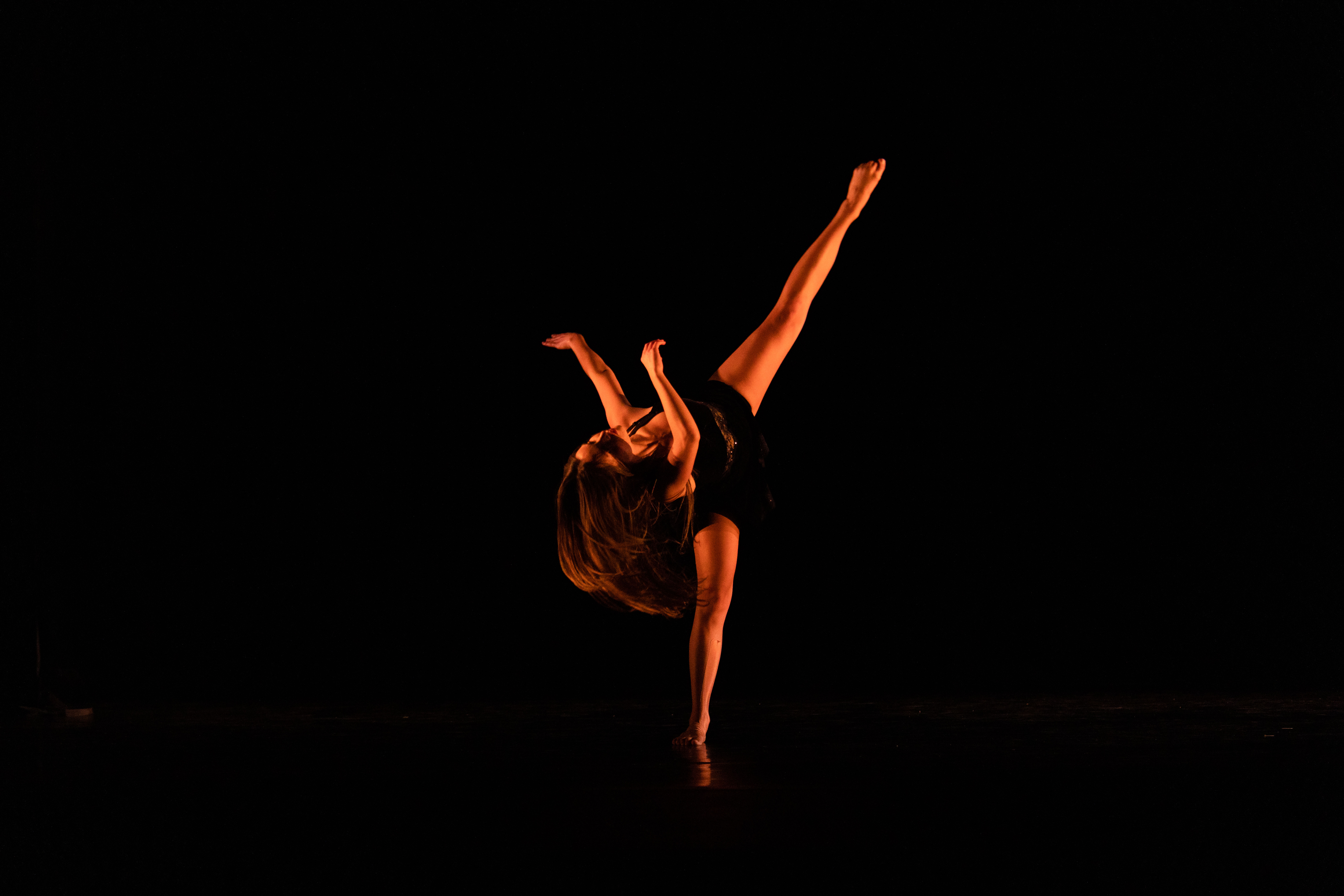 Solo dancer with leg extended perpendicular to the ground