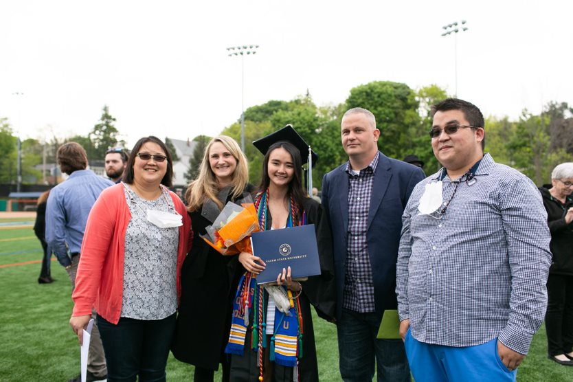 Graduate and family members pose together after ceremony