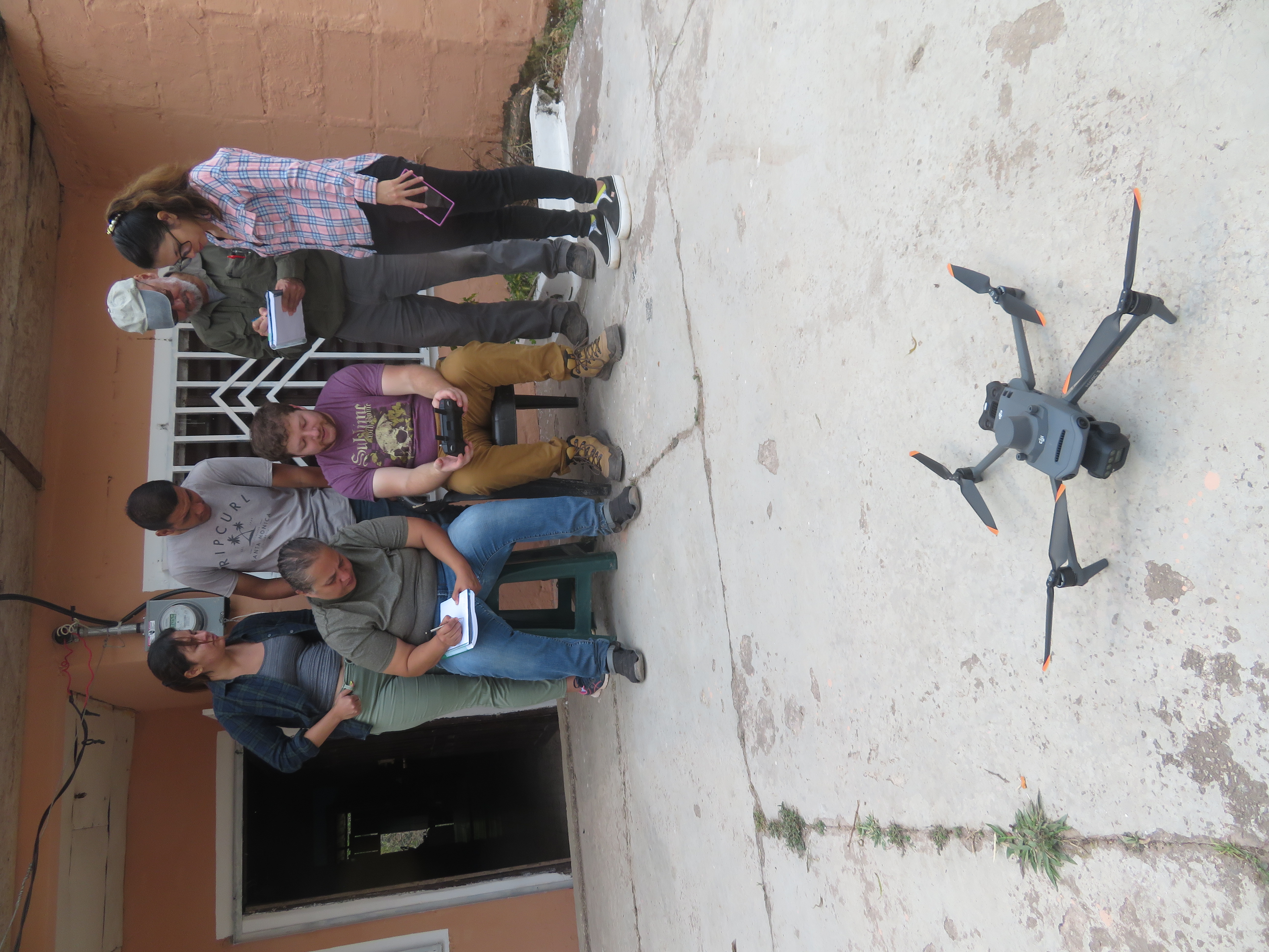Danny teaching trainees how to fly the drone