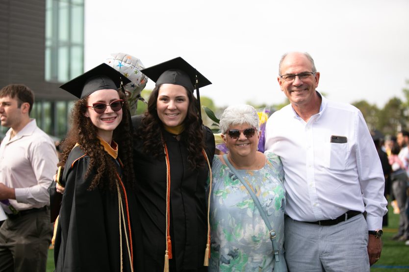 Graduate and family members pose together after ceremony