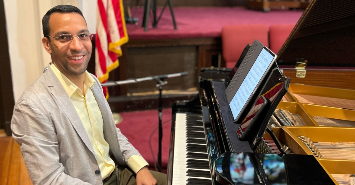 Javier Marquez sits at a piano