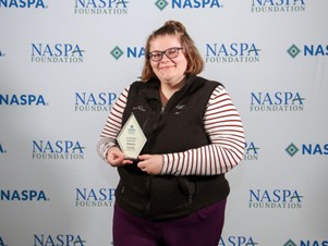 Elaina Curtis, SSU HESA Gradate 2023, holding her Jim Rhatigan Fellowship Award…