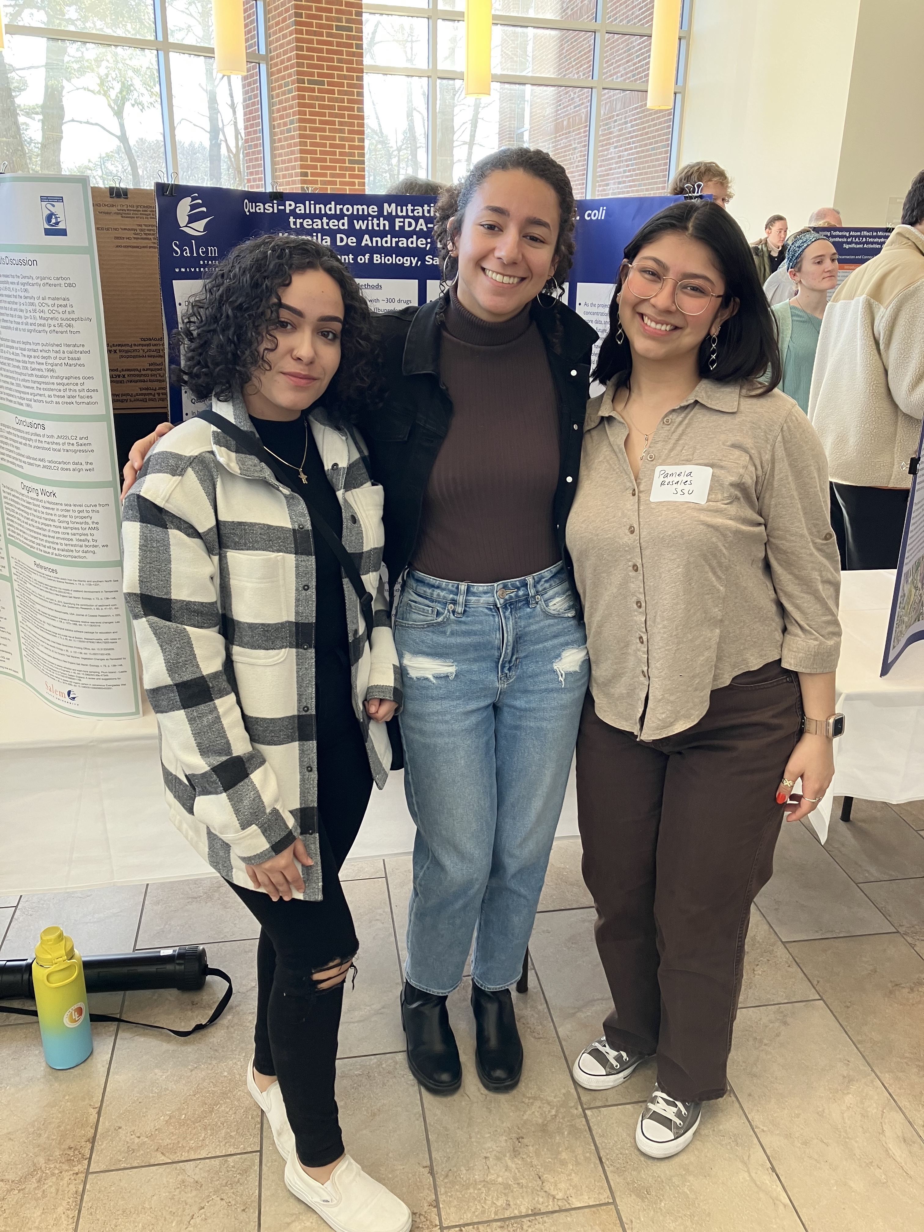 Salem State Biology presenters Kamila De Andrade (middle) and Pamela Rosales (r…