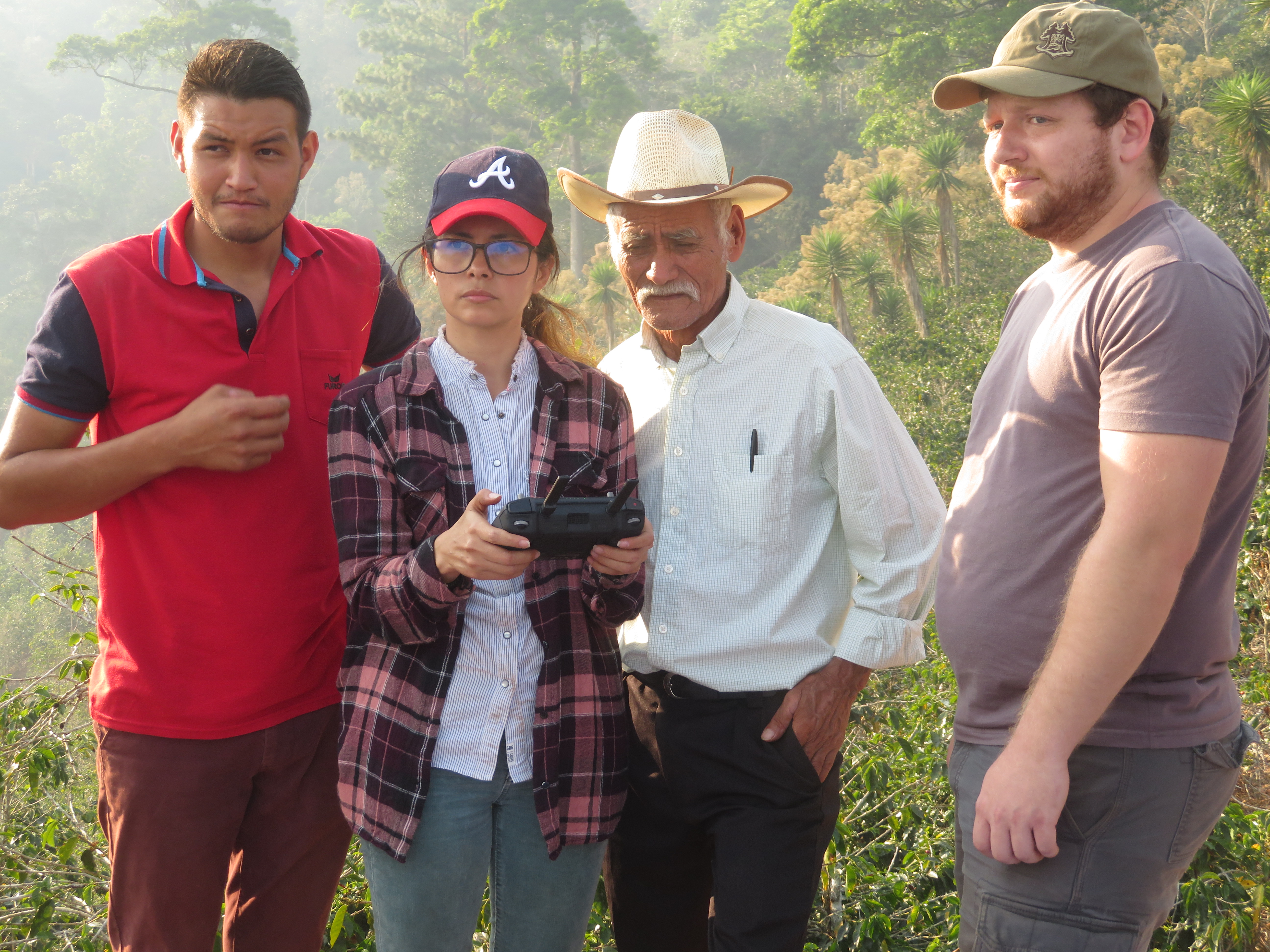 Danny overseeing trainees working with a coffee farmer on mapping a plantation