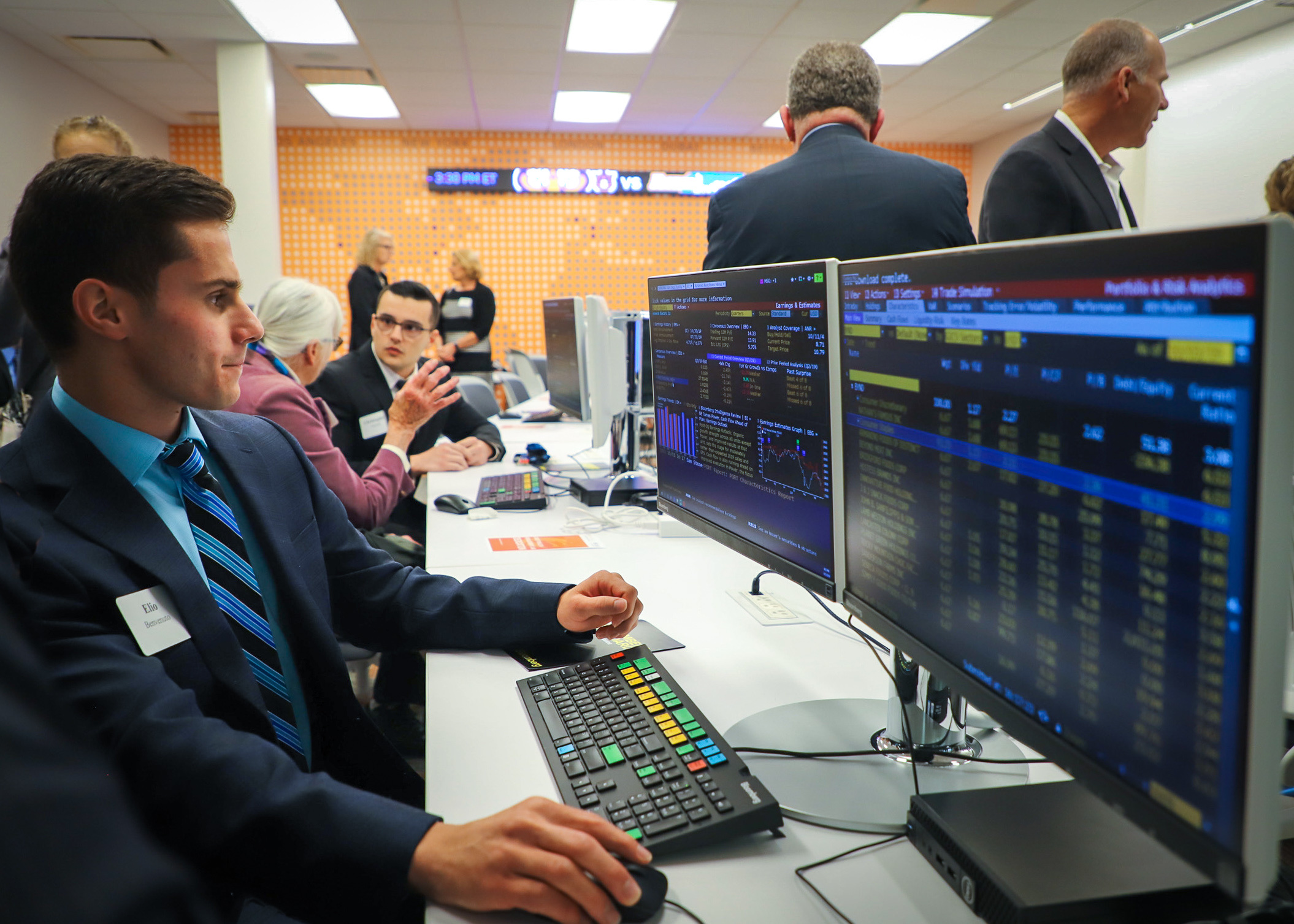 A young male professional sits in the computer lab to work on the Bloomberg Ter…