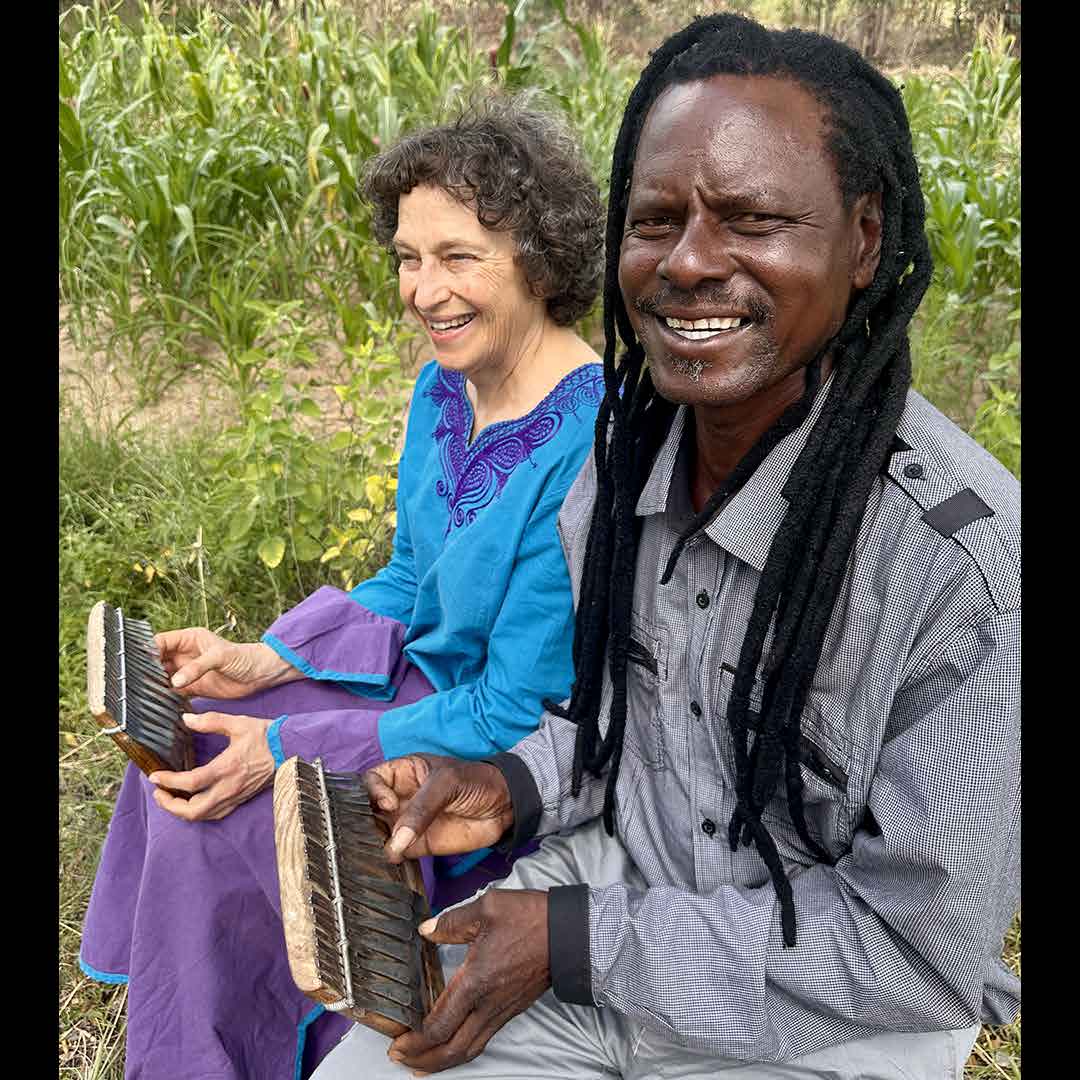 A female and male musician playing mbrias