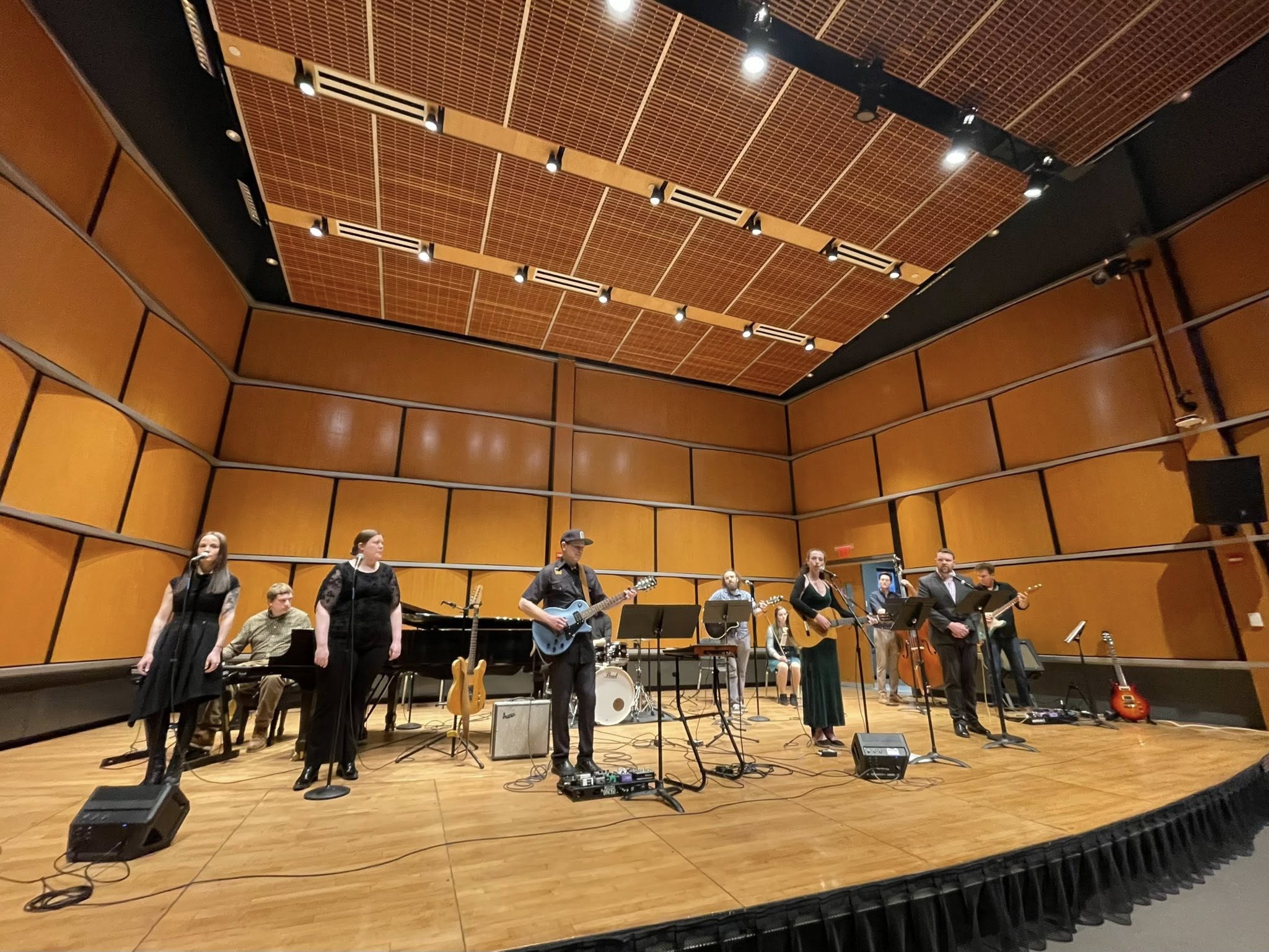 Musicians on a stage with many instruments