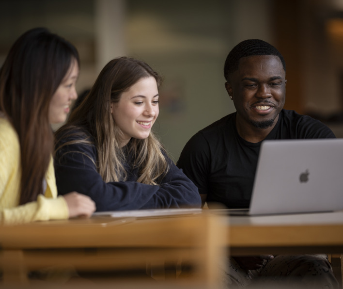 3 Students around a computer