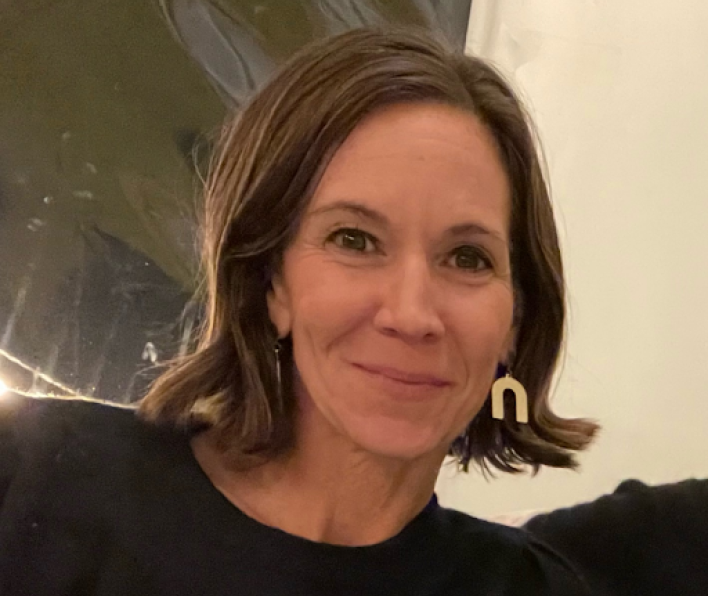 Young woman with brown hair and a blue shirt