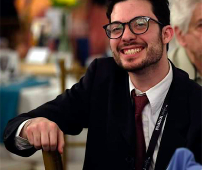 Young man in suit and glasses with brown hair