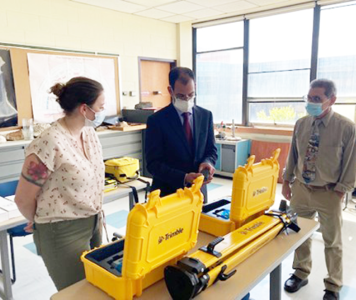 Ron Bisio '91 with student and professor looking at the latest technology in geospatial equipment