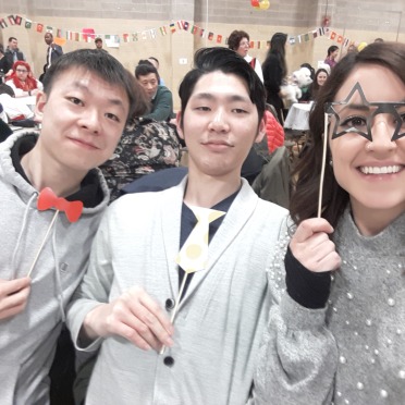 Three Salem State Students hold up party favors at an event