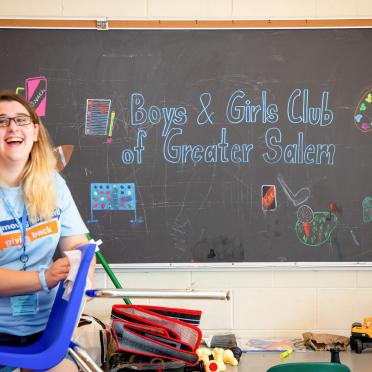 At the 2019 First Year Day of Service, a Salem State student helps clean at the Boys and Girls Club in Salem.