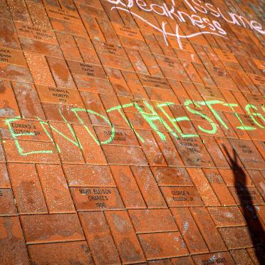 "#End the Stigma" is written in chalk on Alumni Plaza as part of a mental health wellness campaign at Salem State.