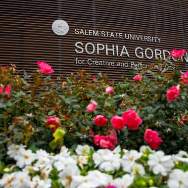 Sophia Gordon Center with flowers framing the building sign.
