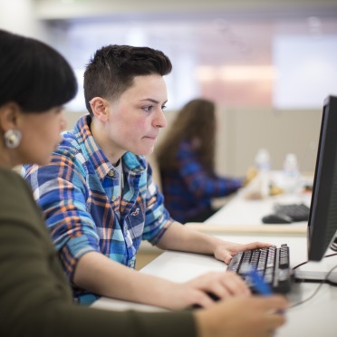 A student works with a counselor to register for classes.