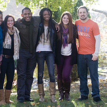 A group of diverse Salem State students gather outside