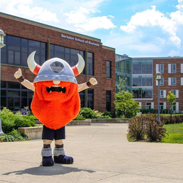 Superfan mascot cheering in front of the Classroom Building