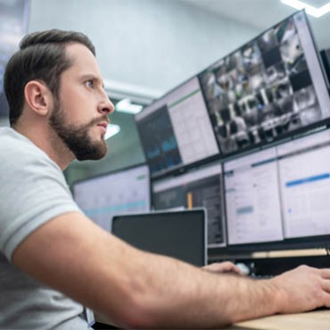 A student works on a surveillance system at a police station